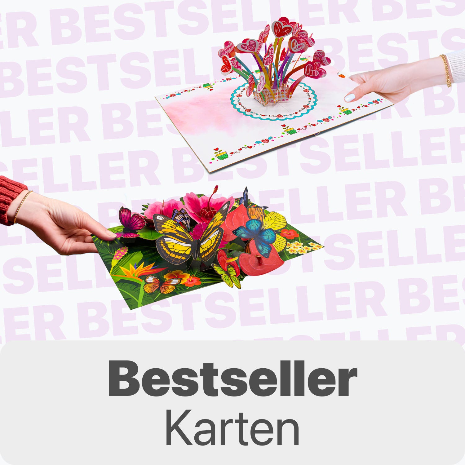 Zwei Hände halten 3D Pop-Up Karten mit bunten Herzen sowie mit Blumen und Schmetterlingen, vor hellem Hintergrund mit dem Wort „Bestseller“ und dem Text „Bestseller Karten“ unten.