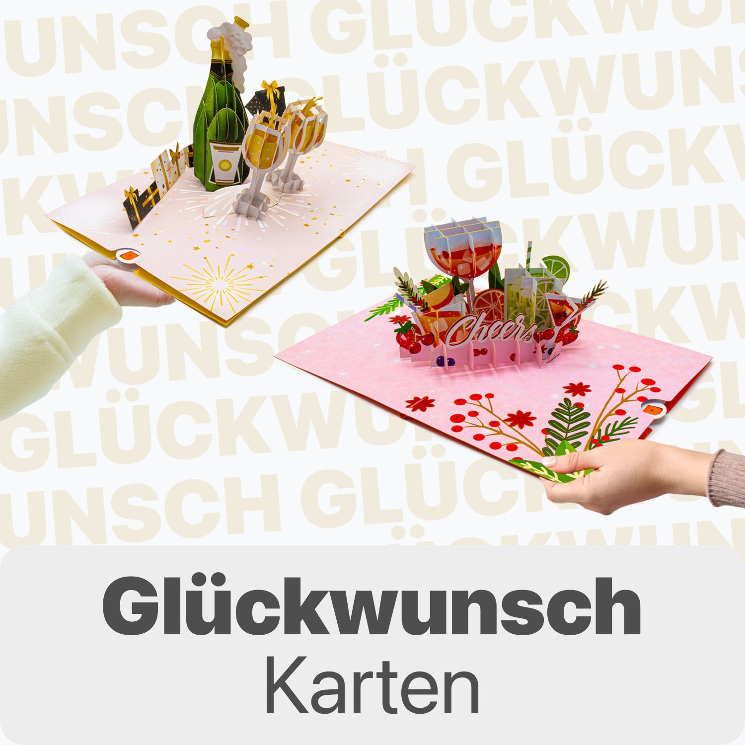 Zwei Hände halten 3D Pop-Up Glückwunschkarten mit Champagnerflasche und Gläsern sowie mit bunten Cocktailgläsern und dem Schriftzug „Cheers“, vor hellem Hintergrund mit dem Wort „Glückwunsch“ und dem Text „Glückwunschkarten“ unten.